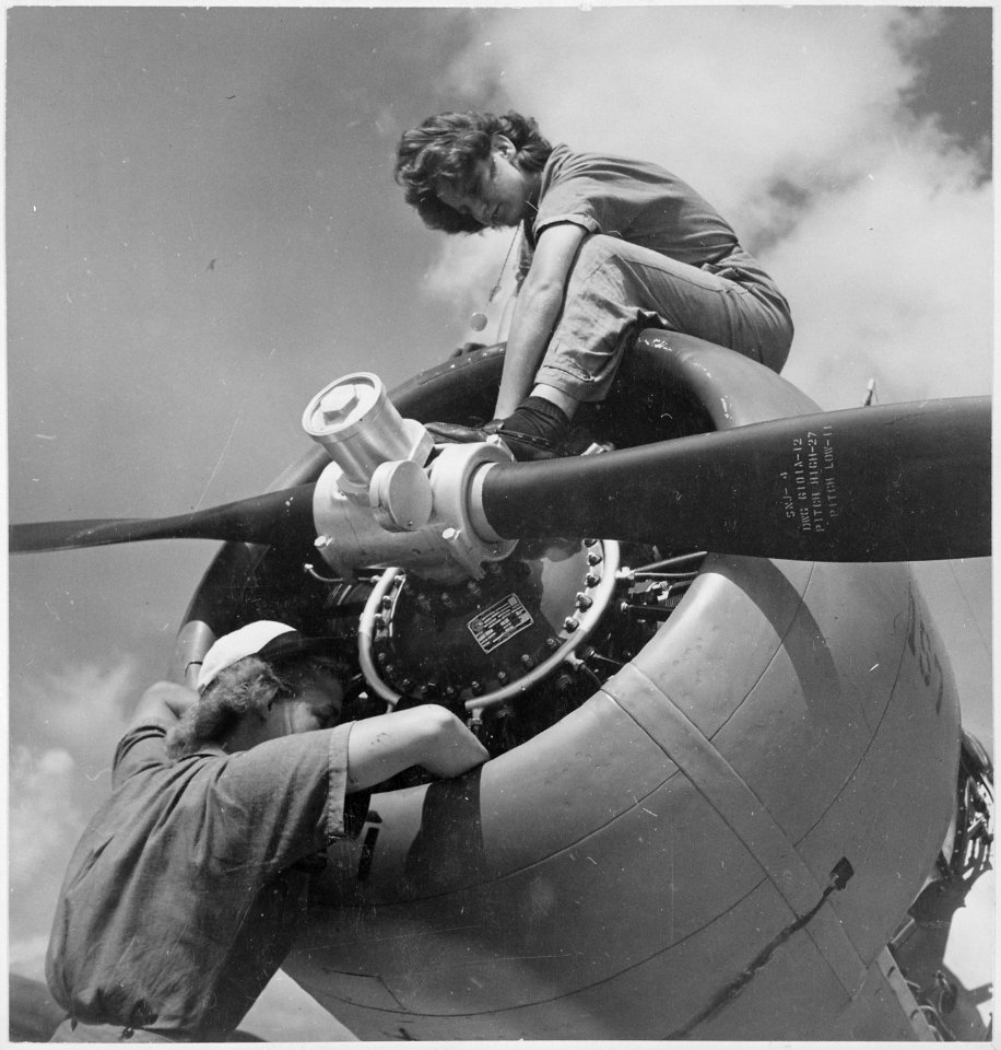 At Naval Air Station Jacksonville, Florida, Bernice Sansburg, an 3-c and Violet Falkum, M 3-c work on the engine of... - NARA - 520608
