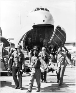 Army medics carry wounded UN personnel to waiting ambulances, after the patients' arrival at Tokyo base in a C-124 - NARA - 542319