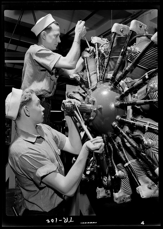 Aviation machinists mates at Navy Pier, Chicago, Illinois. Students working on a complex aircraft engine. - NARA - 520923