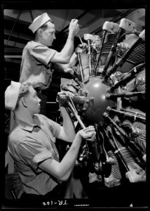 Aviation machinists mates at Navy Pier, Chicago, Illinois. Students working on a complex aircraft engine. - NARA - 520923