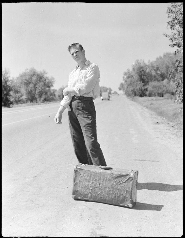 Bakersfield, California. Hitch-hiking. The fourth in a line of thumbers at Bakersfield city limits - NARA - 532090