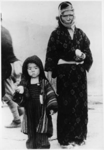 Before noon on August 10, 1945, a mother and her son have received a boiled rice ball from an emergency relief party.... - NARA - 558580