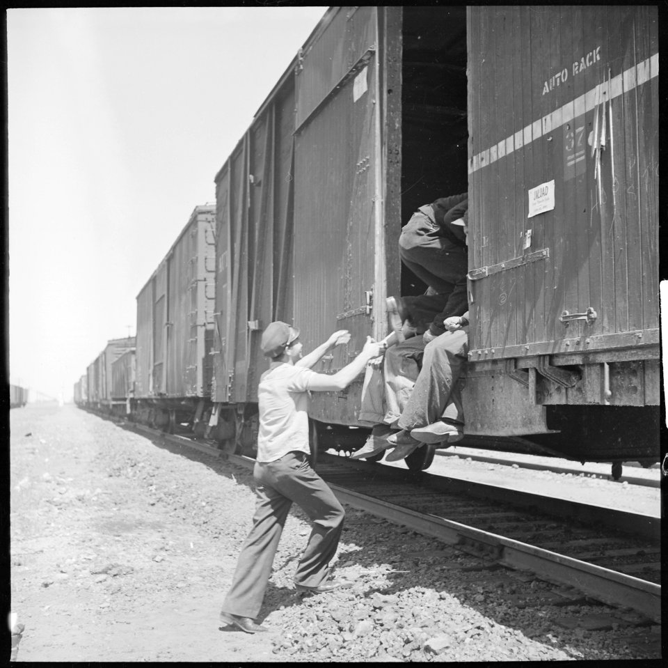 Between Bakersfield and Fresno, California. On the Freights. Hopping a box car in a hurry - NARA - 532073