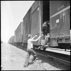Between Bakersfield and Fresno, California. On the Freights. Hopping a box car in a hurry - NARA - 532073