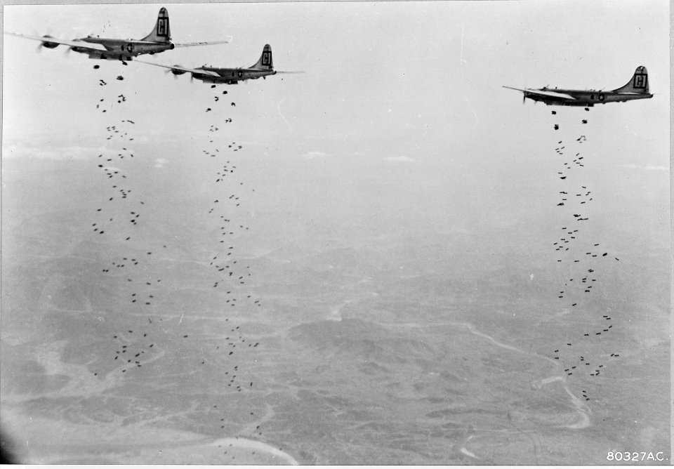 Bomber Command planes of the U.S. Far East Air Forces rain tons of bombs on a strategic military target of the... - NARA - 542229 photo