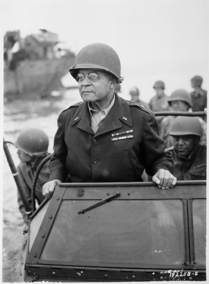 Brigadier General Benjamin O. Davis watches a Signal Corps crew erecting poles, somewhere in France., 08-08-1944 - NARA - 531202