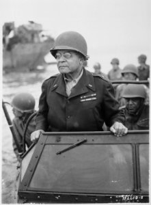 Brigadier General Benjamin O. Davis watches a Signal Corps crew erecting poles, somewhere in France., 08-08-1944 - NARA - 531202