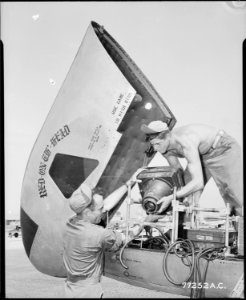 CAMERA TRI-POD, JET PROPELLED. Cameramen mount a giant aerial camera in the nose of a speedy but otherwise unarmed... - NARA - 542195