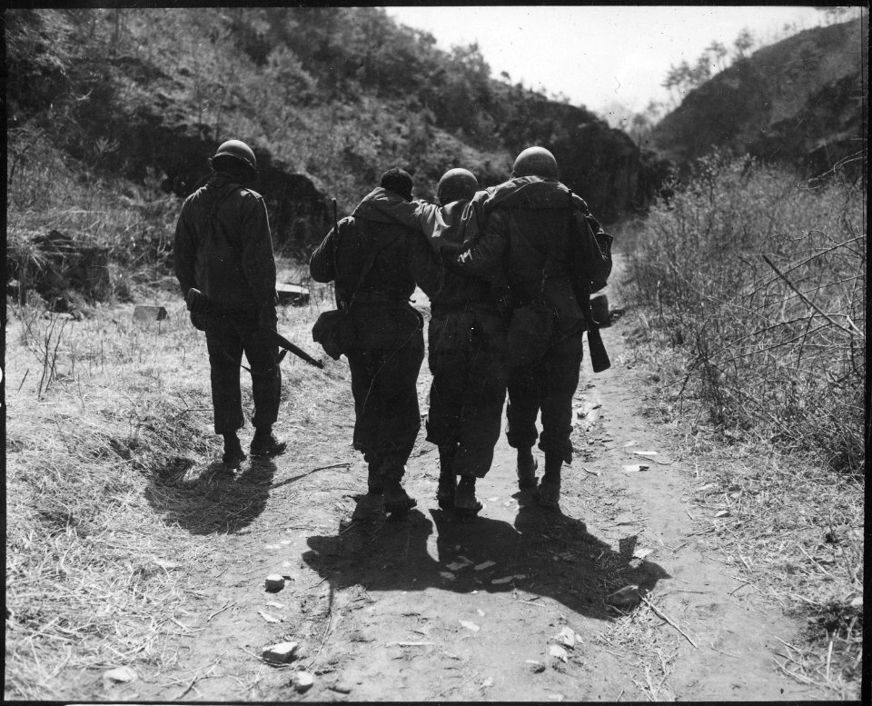 Buddies aid wounded man of 24th Infantry Regiment, after a battle 10 miles south of Chorwon, Korea. - NARA - 531406