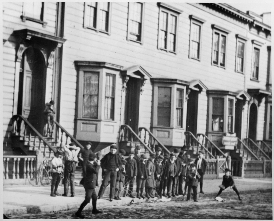 Children play ball in the street in front of typical housing with five rooms per family for $10 to $12 per month. San Fr - NARA - 535471