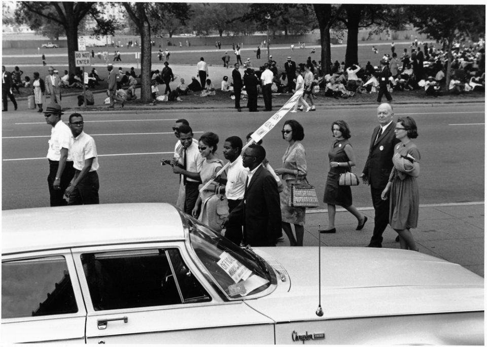 Civil Rights March on Washington, D.C. (Marchers walking and sitting under the trees.) - NARA - 542007