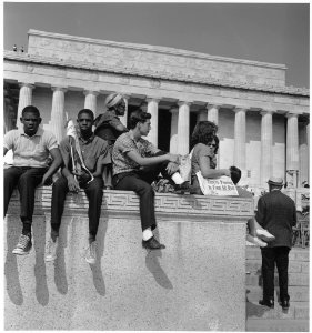 Civil Rights March on Washington, D.C. (Young men and women sitting in front of the Lincoln Memorial.) - NARA - 542048 photo