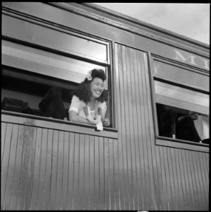 Closing of the Jerome Relocation Center, Denson, Arkansas. An attractive miss, aboard the train for . . . - NARA - 539797
