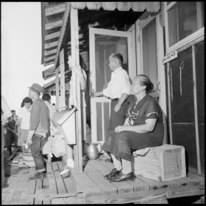 Closing of the Jerome Relocation Center, Denson, Arkansas. An Issei couple sit on their porch and w . . . - NARA - 539783