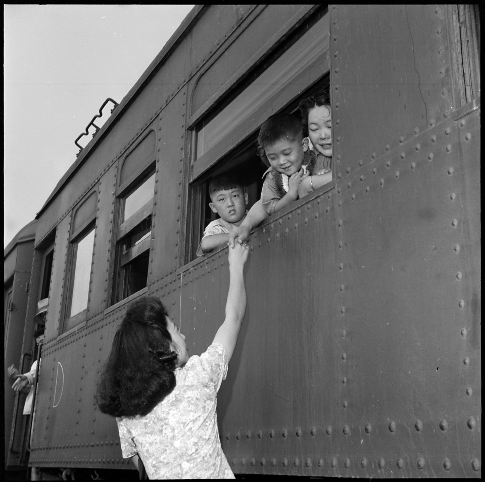Closing of the Jerome Relocation Center, Denson, Arkansas. Fairwell hand clasps as the train bearin . . . - NARA - 539762