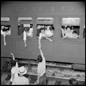 Closing of the Jerome Relocation Center, Denson, Arkansas. Goodbye and good-luck as the train whist . . . - NARA - 539667