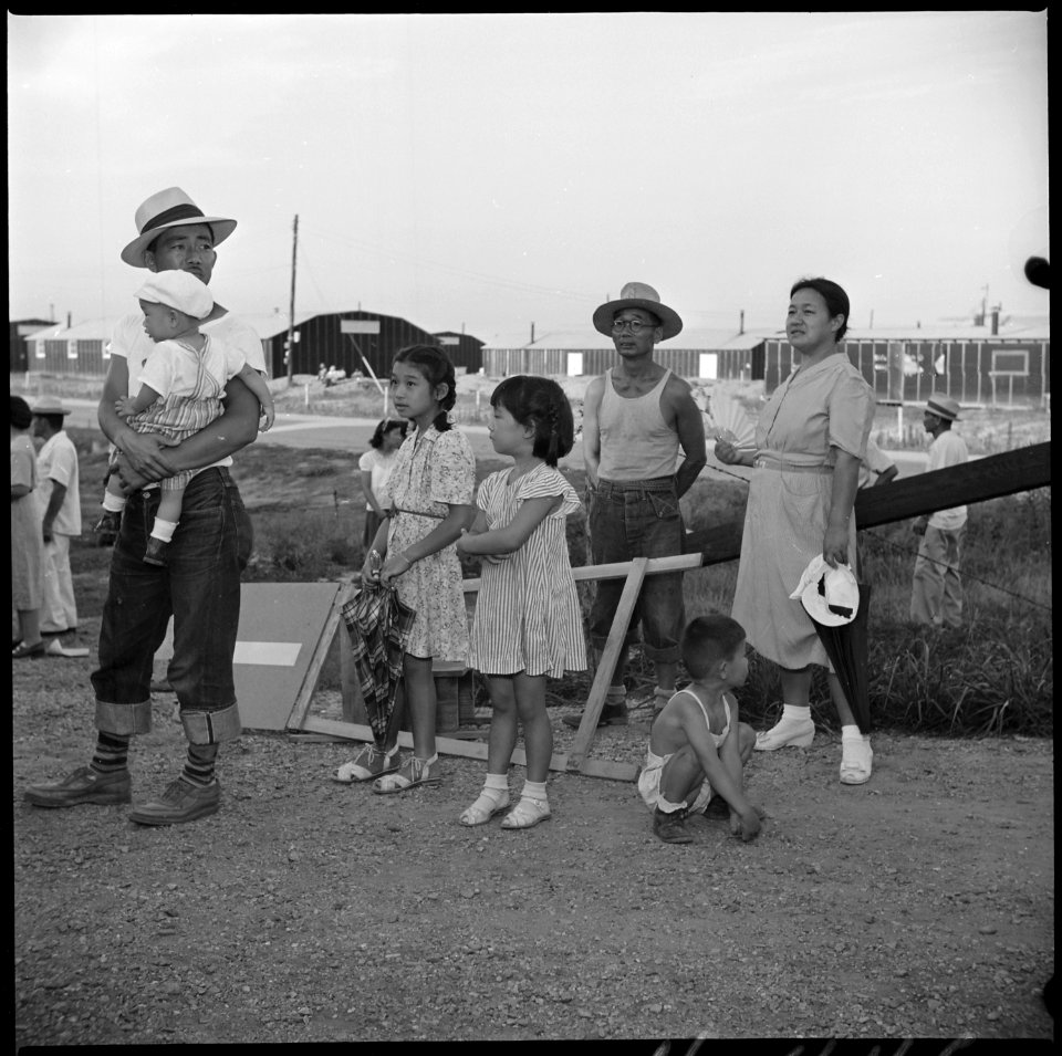 Closing of the Jerome Relocation Center, Denson, Arkansas. A typical Jerome evacuee family watches . . . - NARA - 539660