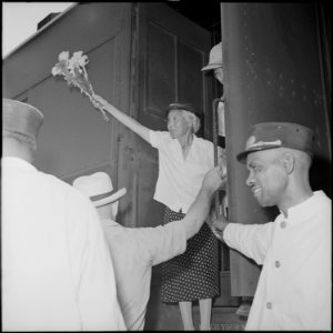 Closing of the Jerome Relocation Center, Denson, Arkansas. An elderly Issei woman waved a bunch of . . . - NARA - 539747
