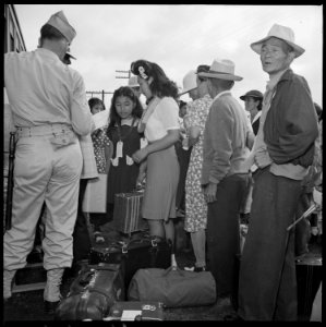 Closing of the Jerome Relocation Center, Denson, Arkansas. Military Police assist evacuees entering . . . - NARA - 539656