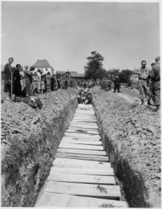 Civilians of Namering, Germany give burial to 800 victims of an SS killing three weeks ago. The bodies had lain in... - NARA - 531279 photo