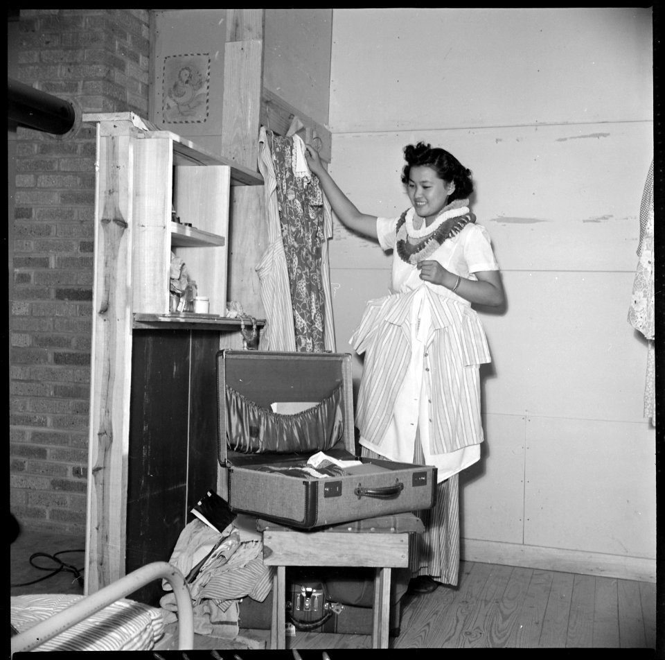 Closing of the Jerome Relocation Center, Denson, Arkansas. Mitzi Matsunaga packs her wardrobe just p . . . - NARA - 539631