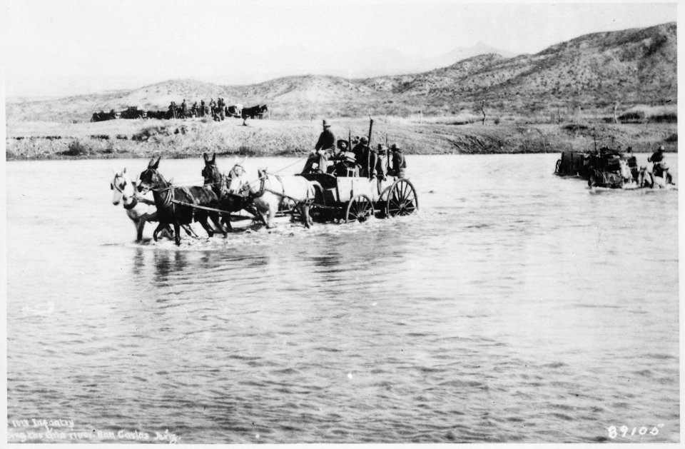 Co. B~ 10th Infantry~, crossing Gila River in buckboard wagons near San Carlos, Ariz. Terr., ca. 1885 - NARA - 530931