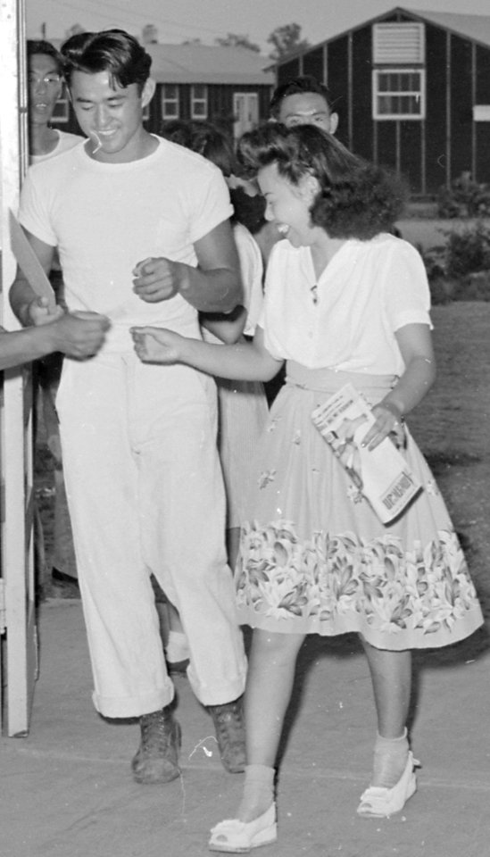 Closing of the Jerome Relocation Center, Denson, Arkansas. Jerome young folks are seen entering the . . . - NARA - 539807 (cropped)