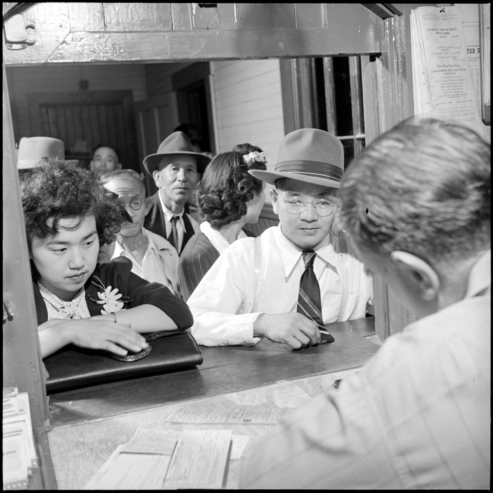 Colorado Relocation Center, Poston, Arizona. In the warm station, everyone stands in line again to . . . - NARA - 539895