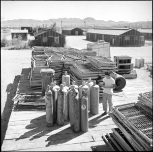 Colorado River Relocation Center, Poston, Arizona. There will be no more need for these army cots i . . . - NARA - 539896 photo