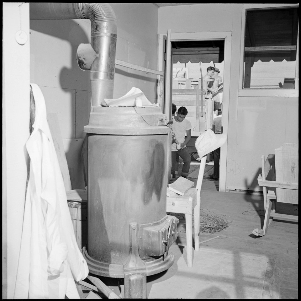 Closing of the Jerome Relocation Center, Denson, Arkansas. The sheet iron stove, prominent fixture . . . - NARA - 539810