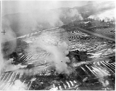 Communist target at Korangpo-ri, Korea, left in smoke and flames after a raid by B-26s of the 452nd Bomb Group. - NARA - 542240 photo