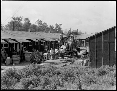 Closing of the Jerome Relocation Center, Denson, Arkansas. Typical moving scene in one of the block . . . - NARA - 539678