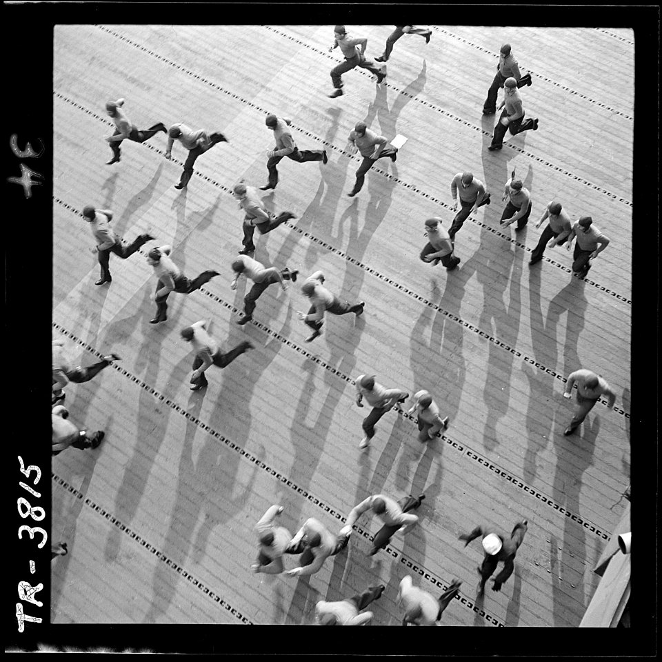 Crewmen aboard USS Yorktown (CV-10) dash to stations as general quarters sound. - NARA - 520942