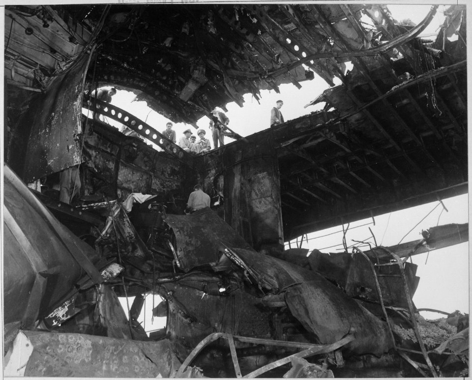 Damaged USS RANDOLPH resulting from a Japanese suicide attack. Damage to overhead hangar and flight deck aft. - NARA - 520655
