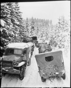 Deep snow banks on a narrow road halt military traffic in the woods of Wallerode, Belgium. 87th Infantry Division - NARA - 531245