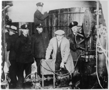 Detroit police inspecting equipment found in a clandestine underground brewery during the prohibition era - NARA - 541928