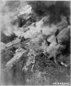 Dense clouds of smoke from earlier attacks by Fifth Air Force tactical aircraft obscures most of the target area as... - NARA - 542231 photo