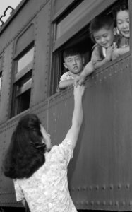 Detail, Closing of the Jerome Relocation Center, Denson, Arkansas. Fairwell hand clasps as the train bearin . . . - NARA - 539762 (cropped)