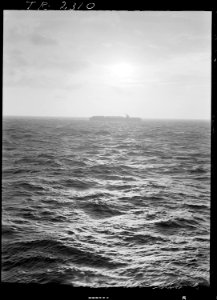 Dusk falls on a baby flat-top (aircraft carrier escort and her brood of winged subhunters). - NARA - 520606