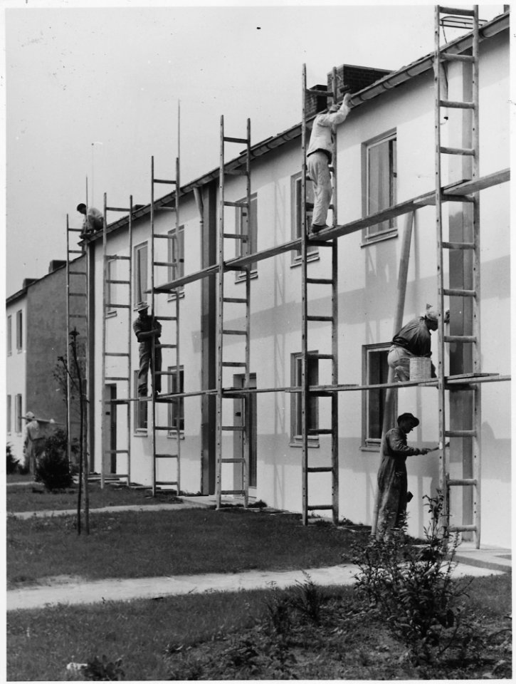 Dortmund, Germany. Painter put finishing touches on Dortmund Housing Project, built to help bring labor stability to... - NARA - 541697