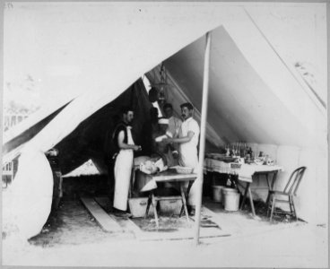 Dressing wounds of natives, Filipino Ward, Division Hospital, Assistant Surgeon J. L. Conant in charge. Greely Collectio - NARA - 524390