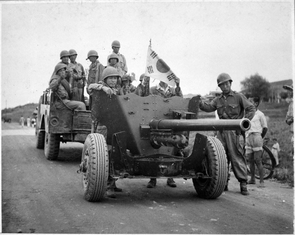 During South Korean evacuation of Suwon Airfield, a 37mm anti-tank gun is hauled out of the area for repairs, by a... - NARA - 541944
