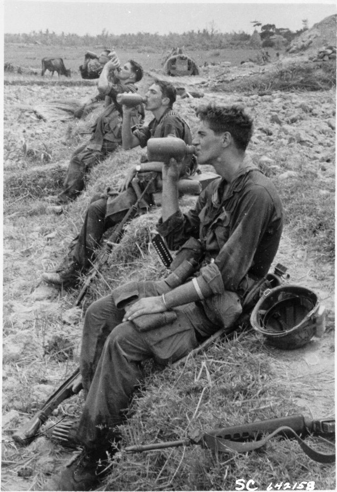 Duc Pho, Vietnam....Members of the 25th Infantry Division drink from their canteens during a break in their patrol... - NARA - 531450
