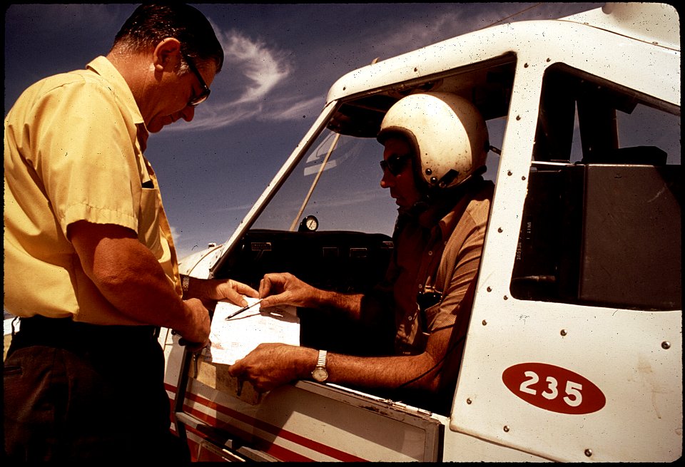 DEPUTY AGRICULTURAL COMMISSIONER CONRAD SCHILLING AND PILOT JOHN GILBERT PREPARE FOR FLIGHT OVER - NARA - 542576