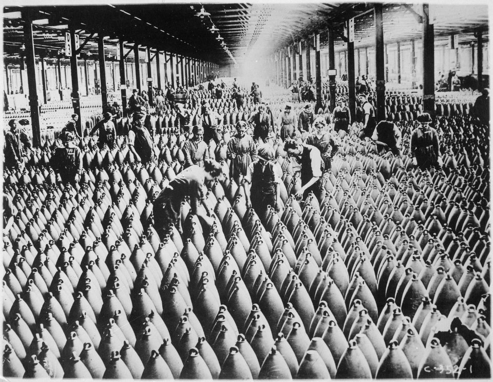 English women in munition factory. Women and men working in storage shed for large shells. In most of the munition cente - NARA - 522871