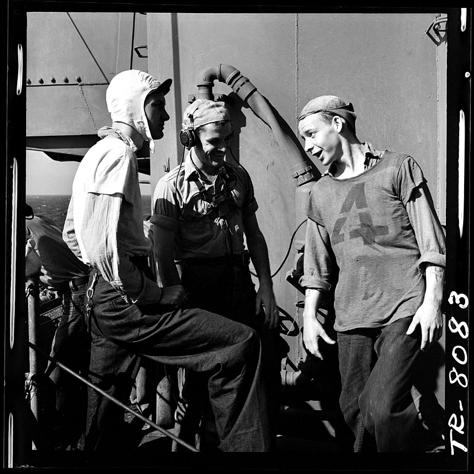 Enlisted personnel aboard USS Lexington (CV-16) in the Pacific. Swapping wise cracks during quiet moment aboard ship. - NARA - 520902