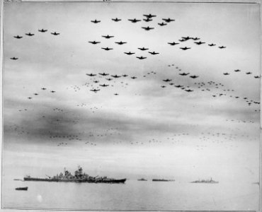 F4U's and F6F's fly in formation during surrender ceremonies, Tokyo, Japan. USS MISSOURI (in) left foreground. - NARA - 520775