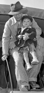 Father and child detail, Granada Relocation Center, Amache, Colorado. Center residents arrive by truck from Amache to board . . . - NARA - 539944 (cropped)