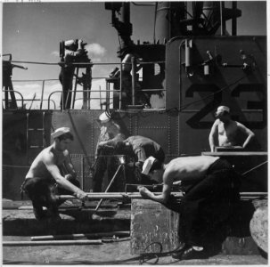 Enlisted men repair and check instruments aboard a submarine just returned to Pearl Harbor. Hawaii - NARA - 520836 photo