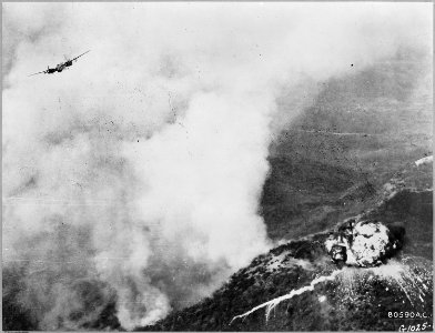 Flames of destruction eat through a concentration of enemy troops on this ridge as the Fifth Air Force B-26 Invader... - NARA - 542233